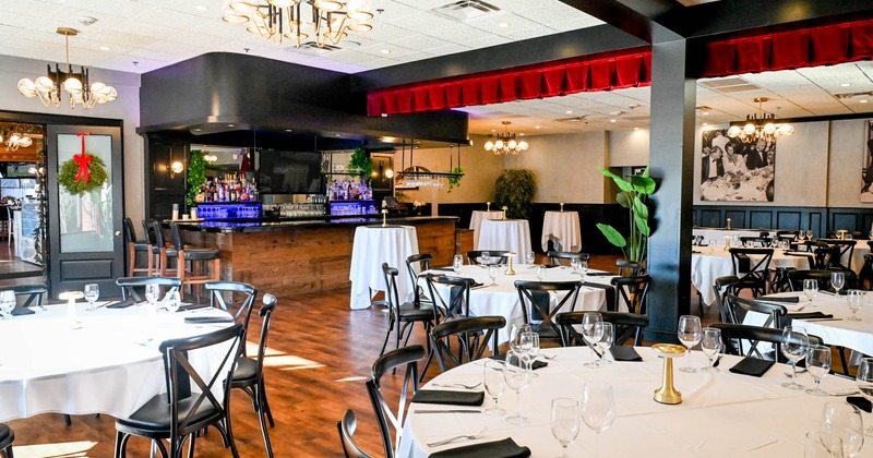 Interior, set tables and chairs, bar in the back