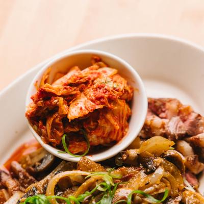 Mixed dish with kimchi and sautéed vegetables.
