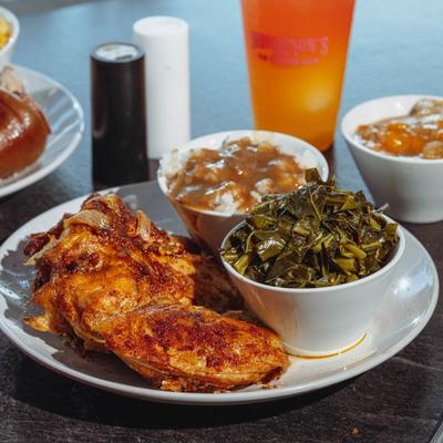 Baked chicken with sides of rice and collards.