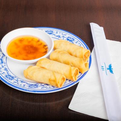 Spring rolls with a side of sweet chili sauce.