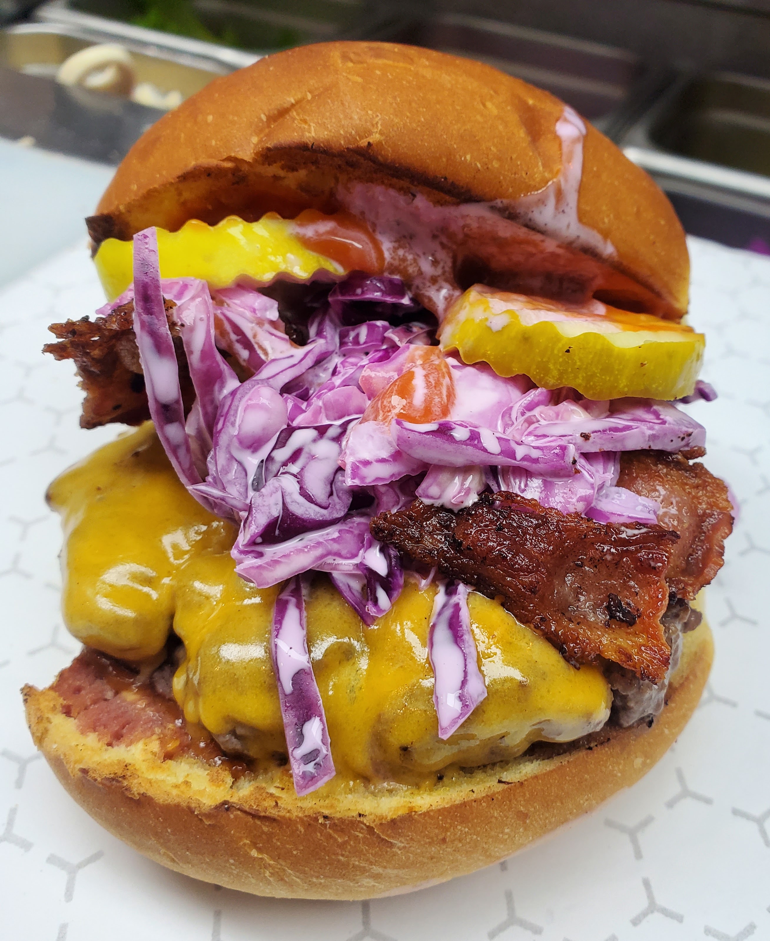 SpOt Burger, with smoked bacon, cheddar, pickles, coleslaw, and SpOt sauce