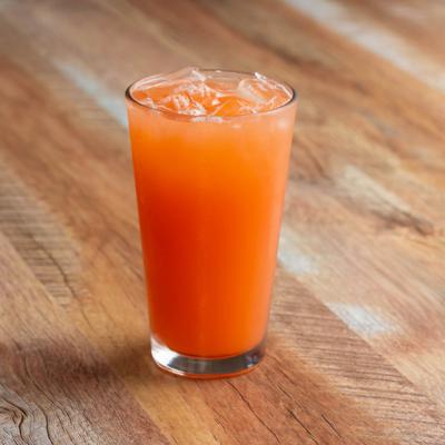 Iced orange drink in a tall glass.