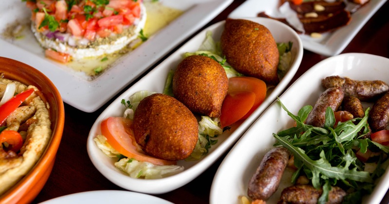 An assortment of dishes with fried kinne ball plate in the middle