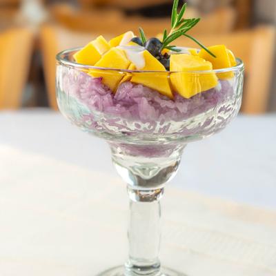 Thai Mango Sticky Rice served in a stemmed glass bowl.