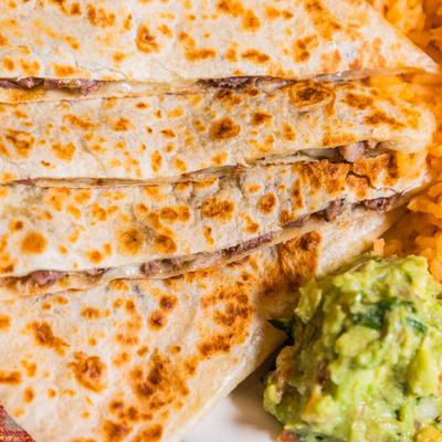 Steak quesadillas, served with rice, beans, and guacamole.