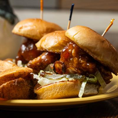 Mini Cluckers with potato wedges, close-up.