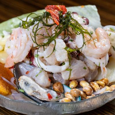 Fish cured with leche de tigre served with slice of sweet potato, and Peruvian corn.