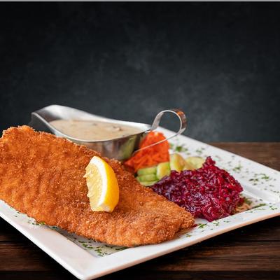 Breaded schnitzel with lemon, creamy mushroom sauce, and beet salad.