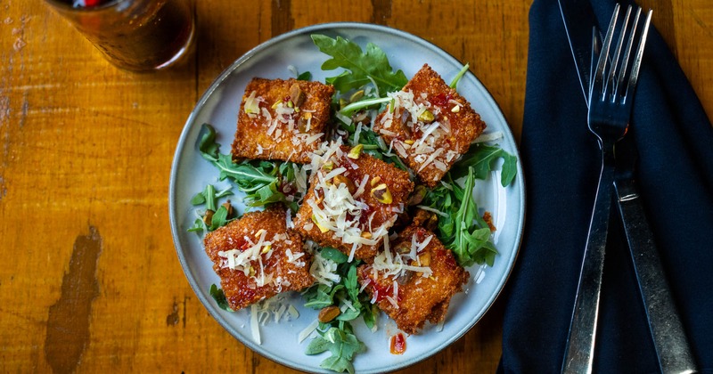 Crispy fried polenta with arugula and grated cheese