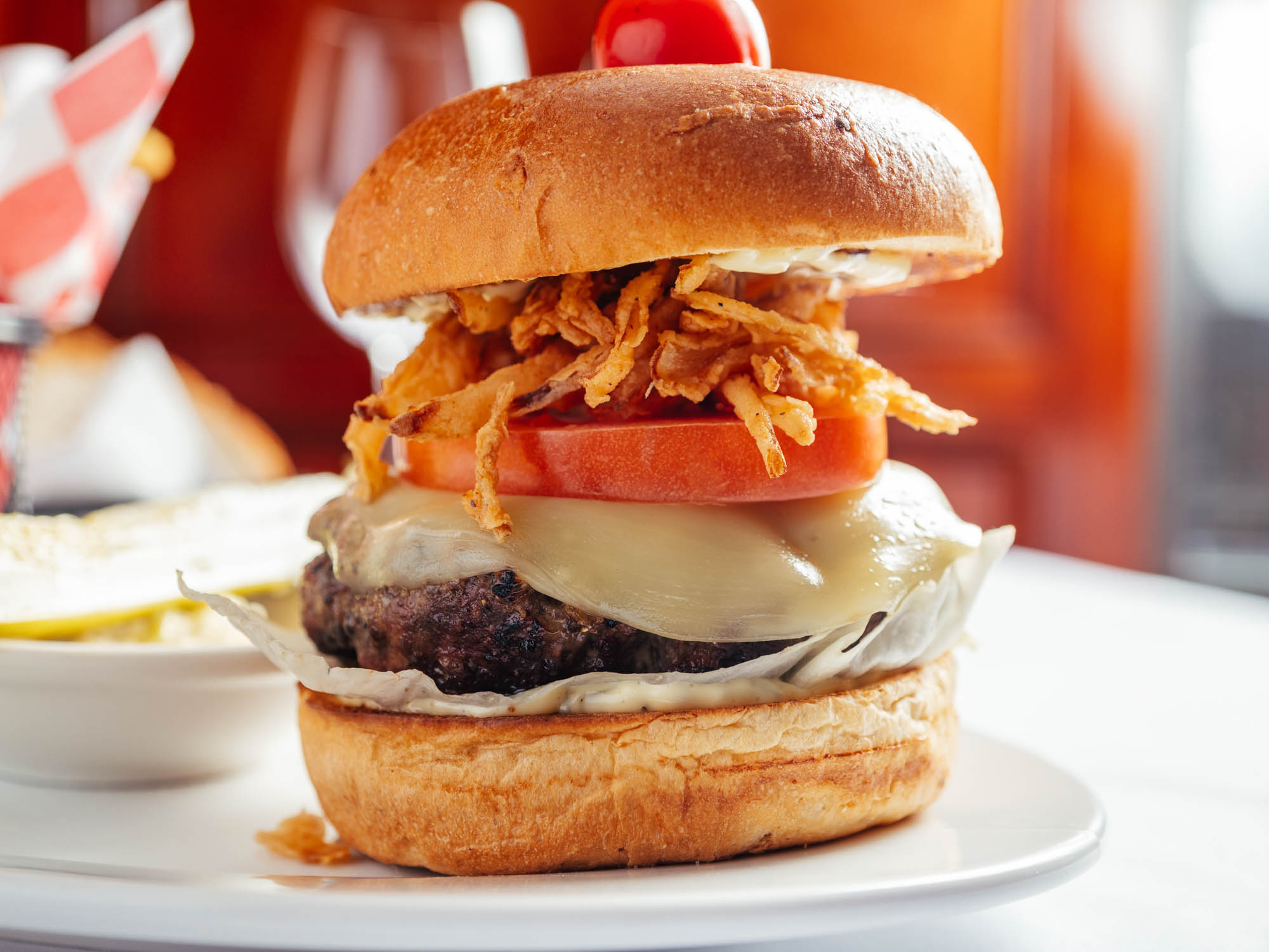 A delicious hamburger on a white plate, ready to be savored