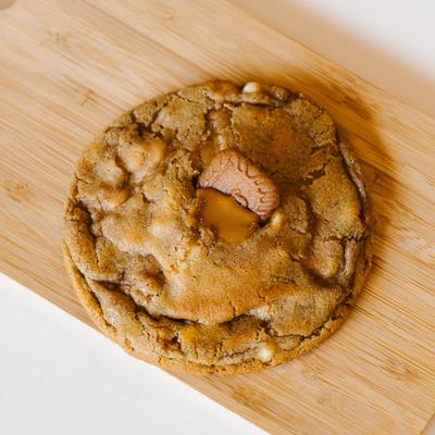 Biscoff Cookie is served on a wooden board.