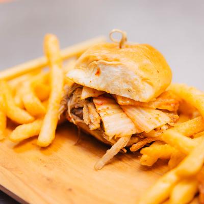 Pulled pork slider topped with Korean BBQ sauce and kimchi, served with fries.