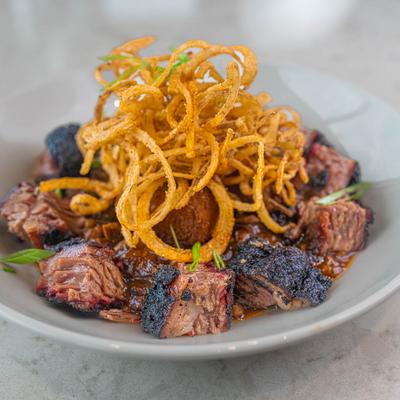 Smoked burnt ends, with beans, cornbread, and onion straws.