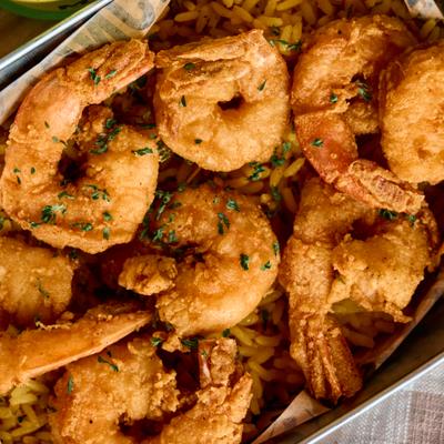 Crispy fried shrimp served on a bed of rice.