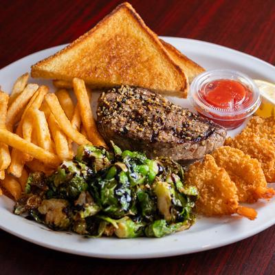 Six ounce Sirloin Steak and four golden Shrimp with toast and brussels.