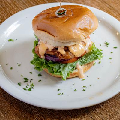 Masa Fried Chicken Sandwich with lettuce and creamy sauce.