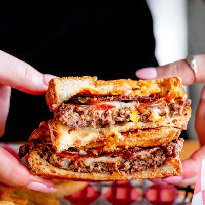 Grilled cheese burger melt with beef patties and bacon.