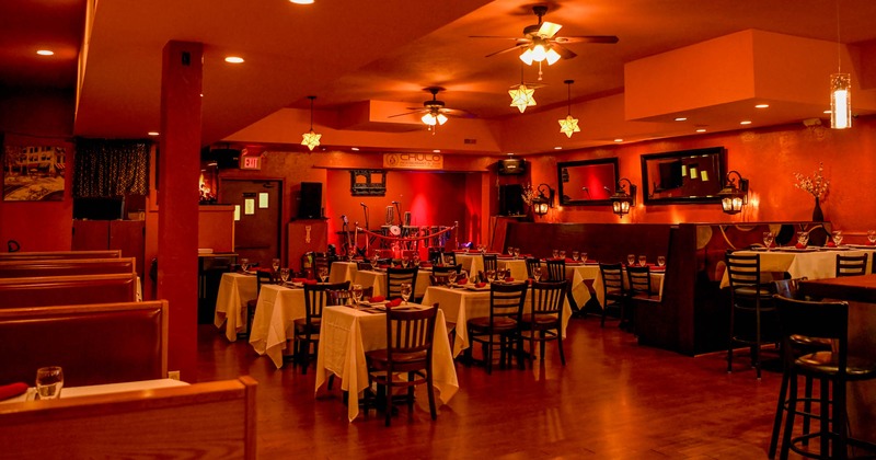 Inside, dining tables, chairs, wooden banquette seating