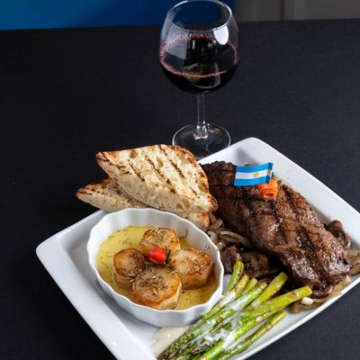 The Hunger Slayer Steak meal and a glass of red wine.