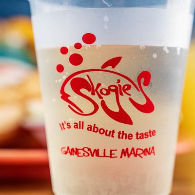 Skogie's cup with a clear drink inside, extreme close up.