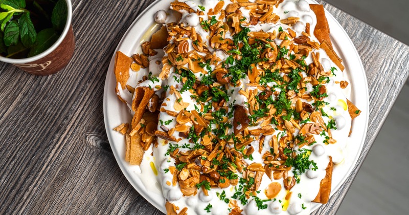 Toasted pita chips with chickpeas, yogurt, and nuts