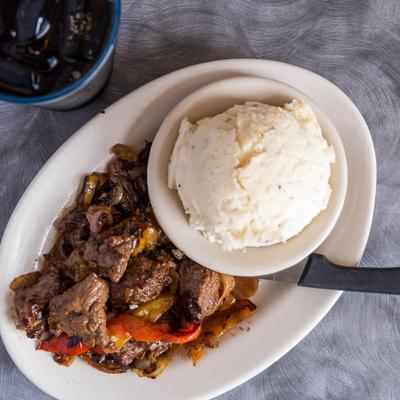 Marinated Sirloin Steak Tips served with mashed potatoes.