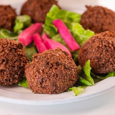 Falafel balls with lettuce and pickled vegetables.