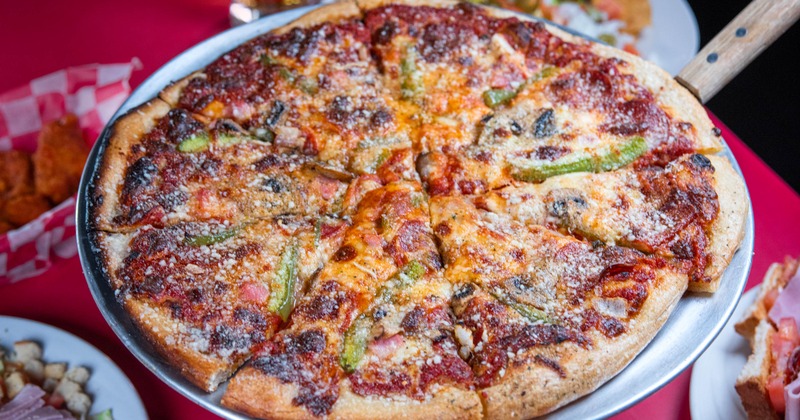 Thin-crust pizza with various toppings