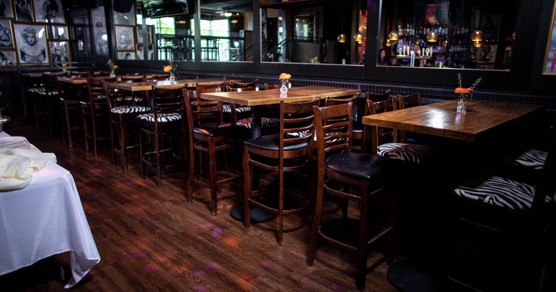 Interior, dining area, high seating tables with chairs, ready for guests, wooden flooring