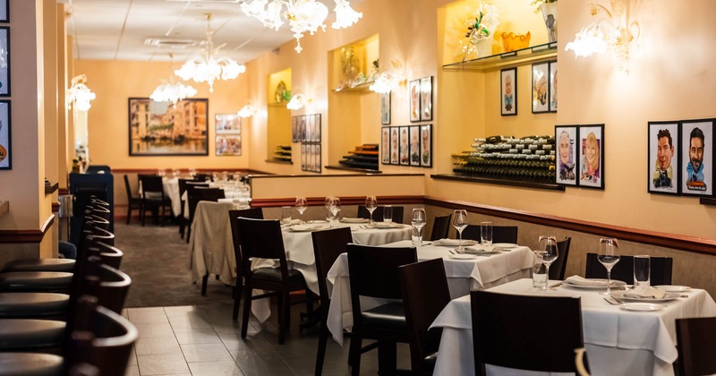 Interior, dining area, tables with chairs, framed caricature pictures on the walls