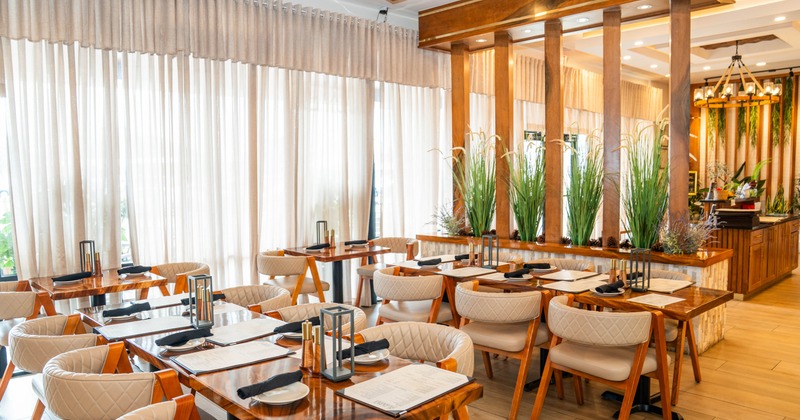 Interior, dining area, wooden to tables for six and two, plant decoration