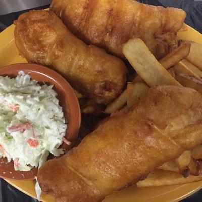 Fish and chips dish with a side of coleslaw