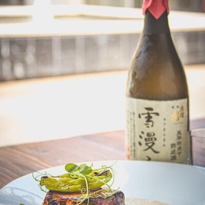 Grilled meat with green decorations on top, closeup