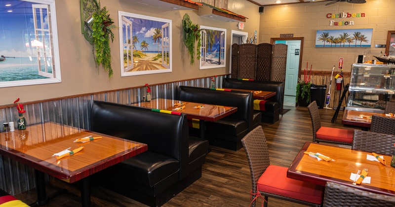 Cozy restaurant interior with colorful booths and framed beach scenes adorn the walls