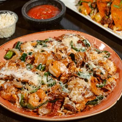 Chef Platter with chicken and shrimp mixed with bacon and vegetables, served oner rice.