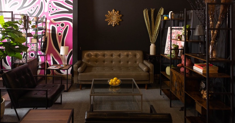 Interior, brown sofa, glass coffee table, abstract pink wall, armchairs