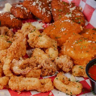 Fried appetizer platter with fried calamari, toasted ravioli, and marinara sauce.