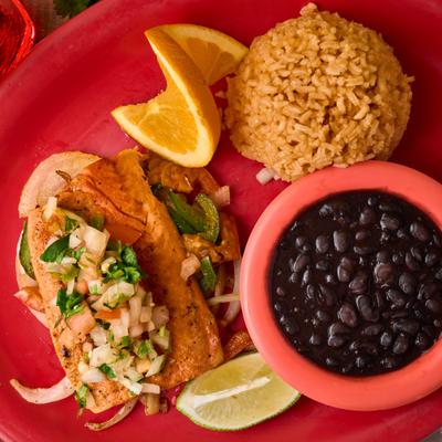 Top-down view of grilled salmon with pico de gallo, rice, and black beans.
