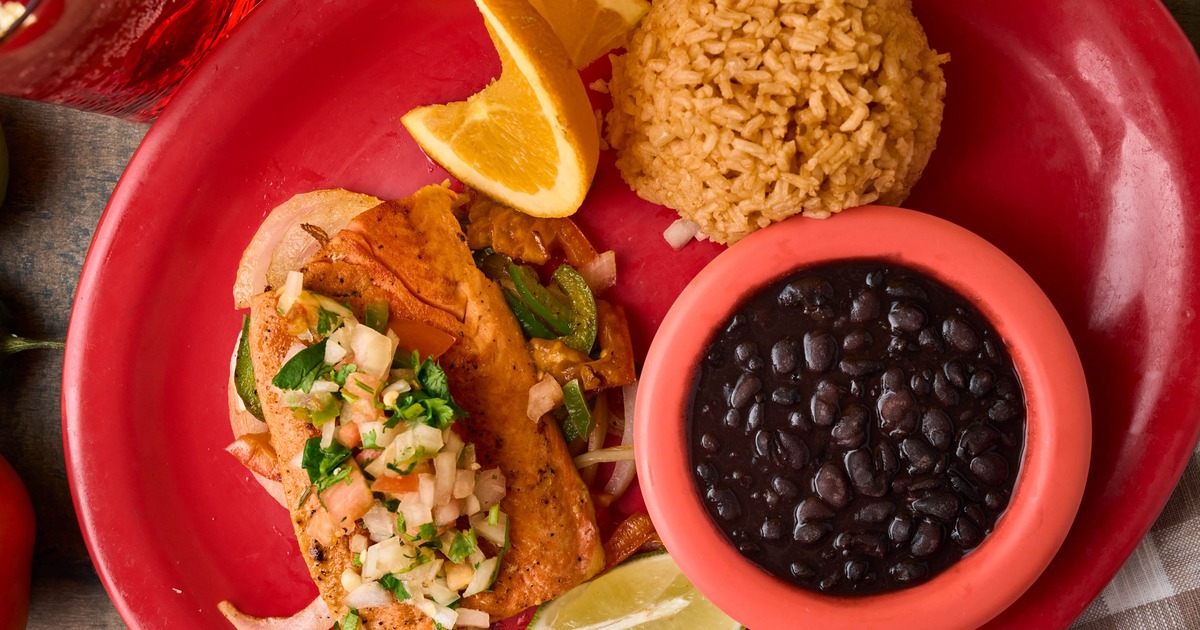 Salmon topped with pico de gallo, served with rice and black beans