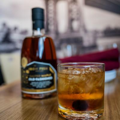 Pre-bottled Old Fashioned cocktail served with a cocktail in a glass.