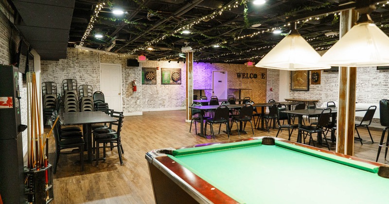 Interior, pool table, tables and chairs behind