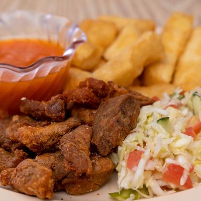 Pork chunks, with tomato sauce, cabbage slaw and Yuca fries