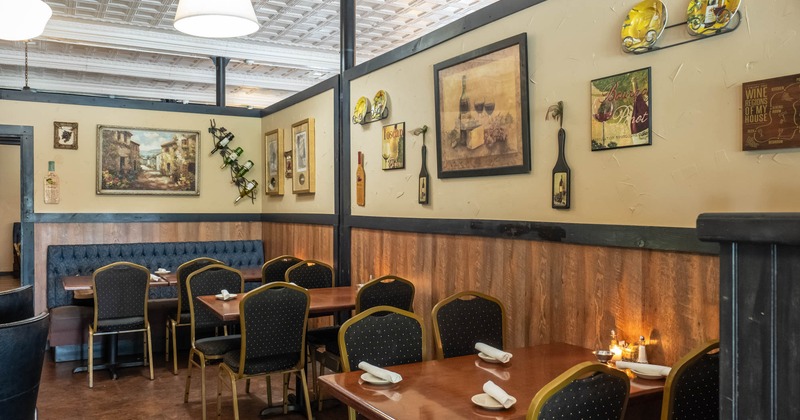 Interior, tables ready for guests, pictures on the wall