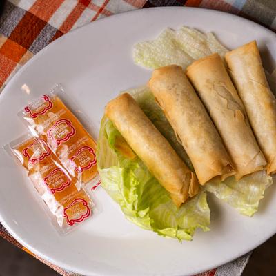 Spring Rolls served over lettuce with packaged plum sauce on the side.