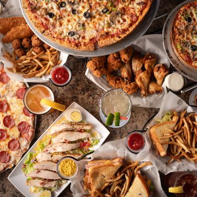 Assortment of dishes served on the table alongside drinks, overhead view.