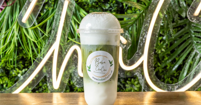 Iced matcha latte in a branded cup