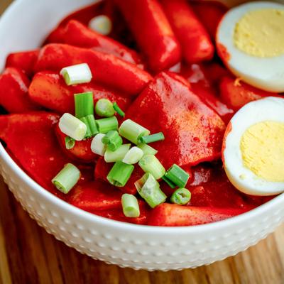 A bowl of red hot, spicy tteokbokki - a popular Korean street food.