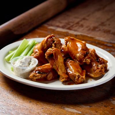 Chicken wings served witha dip and celery sticks.
