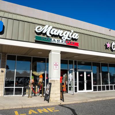 Restaurant storefront under a clear blue sky.