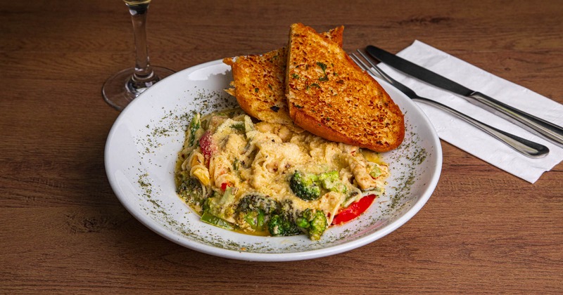 Creamy pasta chicken and vegetable with garlic bread